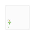 A square white card or notepad with a small simple flower illustration in the lower-left corner, featuring a white petal, yellow center, and green stem and leaves on a plain white background.